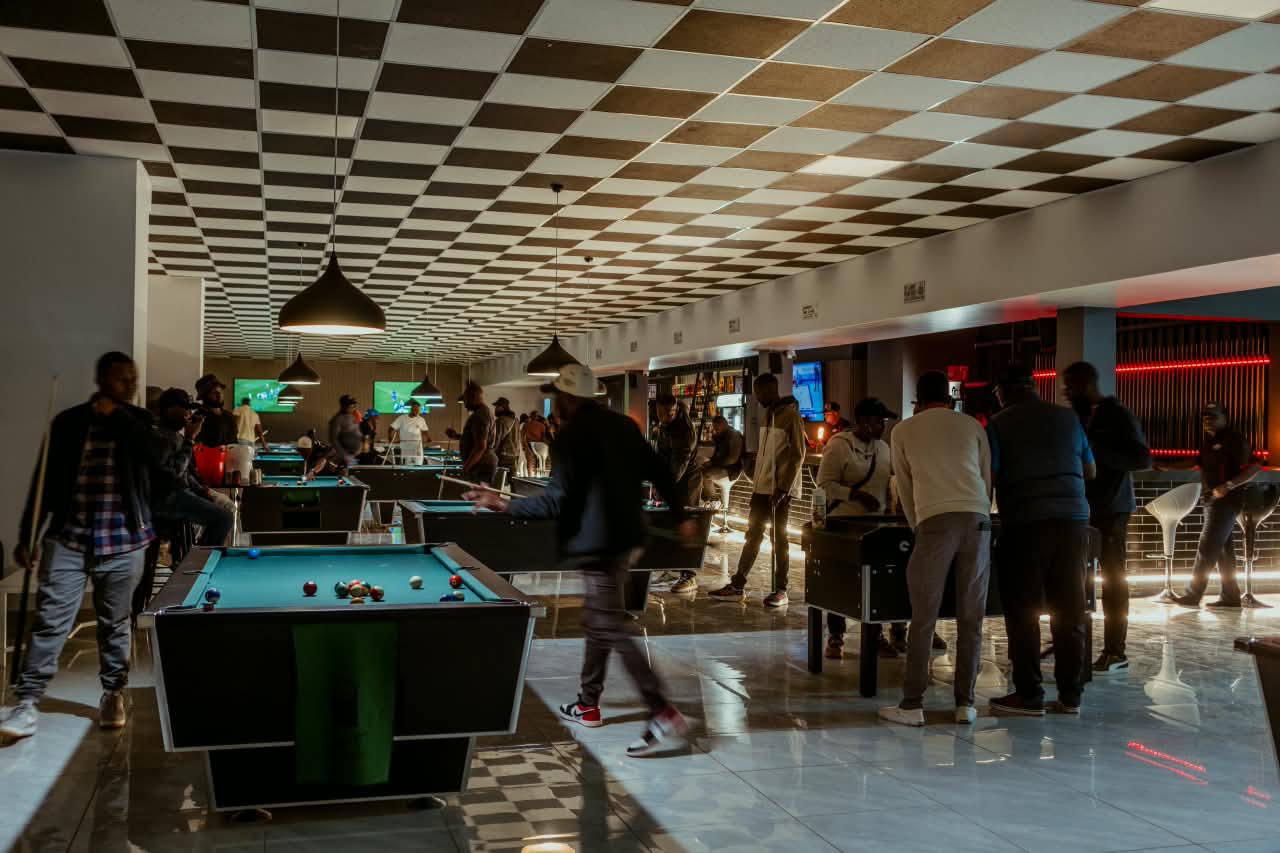 A crowd around pool tables